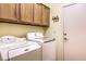Laundry room with washer, dryer, and cabinets for storage at 7824 Homing Pigeon St, North Las Vegas, NV 89084