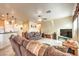 Open living room featuring tile flooring, ceiling fan, and comfortable couches at 7824 Homing Pigeon St, North Las Vegas, NV 89084