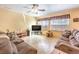 Comfortable living room featuring tile flooring, ceiling fan, and neutral color palette at 7824 Homing Pigeon St, North Las Vegas, NV 89084