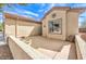 Private outdoor patio space with desert landscaping and stucco wall at 7824 Homing Pigeon St, North Las Vegas, NV 89084