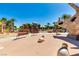 Community playground with slides, swings, picnic tables and mature trees at 7824 Homing Pigeon St, North Las Vegas, NV 89084
