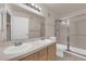 Bathroom featuring double sink vanity, large mirror, and glass-enclosed shower at 7950 W Flamingo Rd # 2019, Las Vegas, NV 89147
