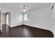 Bright bedroom with dark wood floors, ceiling fan, closet, and a view of the home's exterior at 7950 W Flamingo Rd # 2019, Las Vegas, NV 89147