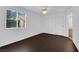 Bright bedroom with dark wood floors, double closets and an exterior view from the large window at 7950 W Flamingo Rd # 2019, Las Vegas, NV 89147