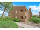 Attractive two-story building featuring an arched balcony, lush greenery, and a well-maintained landscape at 7950 W Flamingo Rd # 2019, Las Vegas, NV 89147