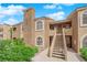 Attractive two-story condo with stucco exterior, balcony, and well-maintained landscaping under a bright, blue sky at 7950 W Flamingo Rd # 2019, Las Vegas, NV 89147