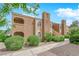Attractive two-story building featuring an arched balcony, lush greenery, and a well-maintained landscape at 7950 W Flamingo Rd # 2019, Las Vegas, NV 89147