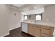Bright kitchen view of countertop, wood cabinets, sink, and breakfast bar pass through to the living room at 7950 W Flamingo Rd # 2019, Las Vegas, NV 89147