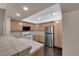 Well-lit kitchen featuring ample counter space, stainless refrigerator, and abundant natural wood cabinetry at 7950 W Flamingo Rd # 2019, Las Vegas, NV 89147