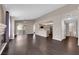 Open floor plan featuring living room with dark floors adjoining kitchen and balcony, ideal for entertaining at 7950 W Flamingo Rd # 2019, Las Vegas, NV 89147