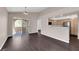 Bright living space with a sliding door balcony access and open flow to the kitchen featuring dark wood floors at 7950 W Flamingo Rd # 2019, Las Vegas, NV 89147