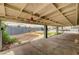Large backyard featuring a covered patio with desert landscaping and mature shrubbery at 804 Cherry Dr, Henderson, NV 89002