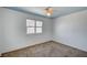 Cozy bedroom with carpet flooring, ceiling fan, and bright light from the window at 804 Cherry Dr, Henderson, NV 89002