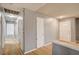 Hallway with hardwood floors, white doors, and neutral wall paint at 804 Cherry Dr, Henderson, NV 89002