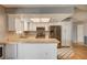 Bright kitchen with white cabinets, stainless steel appliances, and a breakfast bar at 804 Cherry Dr, Henderson, NV 89002