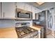 Close-up of the kitchen with stainless steel appliances and light countertops at 804 Cherry Dr, Henderson, NV 89002