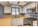 Close-up of kitchen with light countertops, a stainless steel sink, and a gas stovetop at 804 Cherry Dr, Henderson, NV 89002