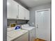 Laundry room including washer, dryer, and cabinets for storage at 804 Cherry Dr, Henderson, NV 89002