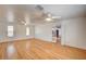 Bright living room with hardwood floors, ceiling fans, and glass french doors with views of the kitchen at 804 Cherry Dr, Henderson, NV 89002