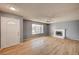 Bright living room features hardwood floors, a white brick fireplace, and a large window at 804 Cherry Dr, Henderson, NV 89002