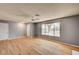 Open living room with hardwood floors, a neutral color palette, and large windows overlooking the front yard at 804 Cherry Dr, Henderson, NV 89002