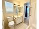 Bathroom featuring accessible grab bars, a toilet, and a sink with mirrors at 810 E Calvada Blvd, Pahrump, NV 89048