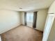 Bedroom with neutral carpet, a window with curtains, and built-in closet at 810 E Calvada Blvd, Pahrump, NV 89048