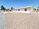 Side view of a single-story home featuring low maintenance gravel landscaping at 810 E Calvada Blvd, Pahrump, NV 89048