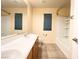 Well-lit bathroom featuring double sinks, tile flooring, and a shower-tub combination at 8161 Cane Creek Mill Ct, Las Vegas, NV 89131