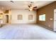 Large living room featuring neutral carpeting and paint, with high ceilings and an open concept at 8161 Cane Creek Mill Ct, Las Vegas, NV 89131