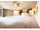 Bright and airy living room featuring neutral decor, ceiling fan, and easy access to the patio at 8161 Cane Creek Mill Ct, Las Vegas, NV 89131