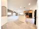 Open floor plan with kitchen featuring a breakfast bar and views of the large living space at 8161 Cane Creek Mill Ct, Las Vegas, NV 89131