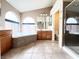 Bathroom showcasing dual vanities, a soaking tub, and a walk-in shower at 8161 Cane Creek Mill Ct, Las Vegas, NV 89131