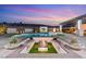 Beautifully designed backyard with a pool, spa, modern fire pit, and comfortable seating arrangements at 82 Glade Hollow Dr, Las Vegas, NV 89135