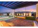 Relaxing outdoor patio with a pergola, daybed swing, and serene landscape at 82 Glade Hollow Dr, Las Vegas, NV 89135