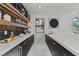 Stylish home bar boasts white countertop, dark cabinets, wood accents, and open shelving at 82 Glade Hollow Dr, Las Vegas, NV 89135