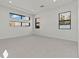 Spacious bedroom featuring neutral paint, large windows, and plush carpeting at 82 Glade Hollow Dr, Las Vegas, NV 89135