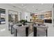 Open-concept dining area with modern table, unique chairs, and view into the luxurious kitchen at 82 Glade Hollow Dr, Las Vegas, NV 89135