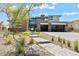 Stylish home displaying modern design, stone accents, and a landscaped front yard at 82 Glade Hollow Dr, Las Vegas, NV 89135