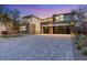 Stunning facade with modern garage door, neutral tones, and meticulously paved driveway at 82 Glade Hollow Dr, Las Vegas, NV 89135