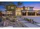 Beautiful home showcasing stone accents, a modern garage door, and landscaped front yard at 82 Glade Hollow Dr, Las Vegas, NV 89135