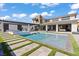 Modern home featuring a large pool, landscaped yard, and luxurious outdoor living spaces at 82 Glade Hollow Dr, Las Vegas, NV 89135