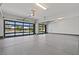 Spacious garage with glass panel doors offering natural light and modern epoxy flooring at 82 Glade Hollow Dr, Las Vegas, NV 89135