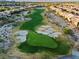 Scenic aerial view of a golf course with manicured greens and sand traps surrounded by beautiful homes at 82 Glade Hollow Dr, Las Vegas, NV 89135