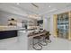 Gourmet kitchen with large island, bar stools, elegant lighting, and a stunning built-in wine rack at 82 Glade Hollow Dr, Las Vegas, NV 89135