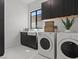 Bright laundry room with white appliances, dark cabinets, a window, and a farmhouse-style sink at 82 Glade Hollow Dr, Las Vegas, NV 89135