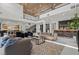 Spacious living room with marble fireplace, soaring ceilings, and adjacent bar area perfect for entertaining at 82 Glade Hollow Dr, Las Vegas, NV 89135
