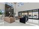 Living room boasts a marble fireplace, plush seating and sliding doors leading to an outdoor entertaining area at 82 Glade Hollow Dr, Las Vegas, NV 89135