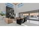 Modern living room with a high ceiling, fireplace, and sliding glass doors at 82 Glade Hollow Dr, Las Vegas, NV 89135