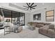 Comfortable living area with designer sofa, large sliding glass doors to patio, and modern ceiling fan at 82 Glade Hollow Dr, Las Vegas, NV 89135